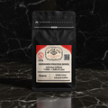 Chillu 100g whole bean infused coffee in a matte black bag on dark marble — Black Eye Coffee Roasters