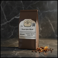 Warm Spice Blend 100g coffee bag on dark marble countertop